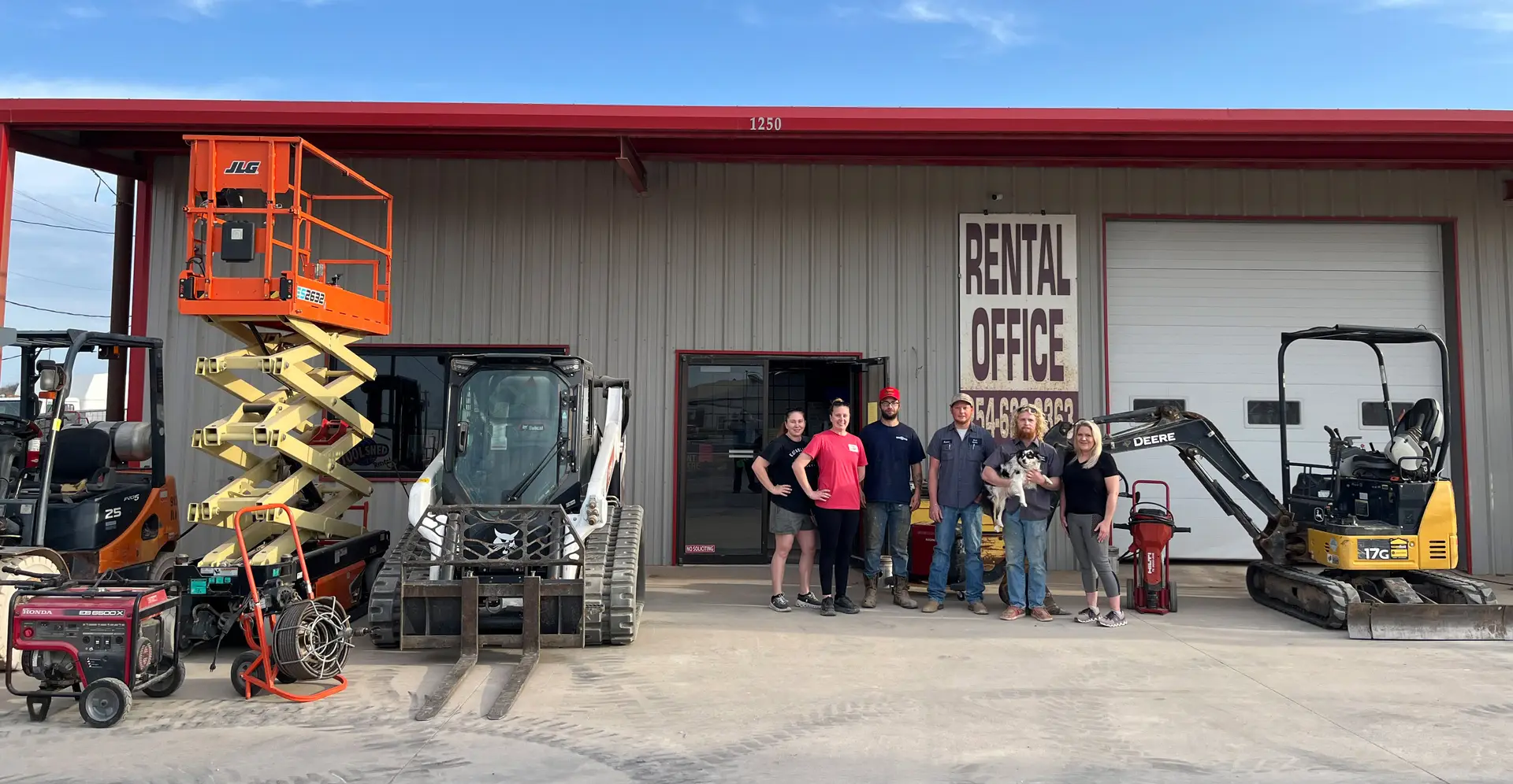 grandpaw's tool shed rental team photo in front of their store
